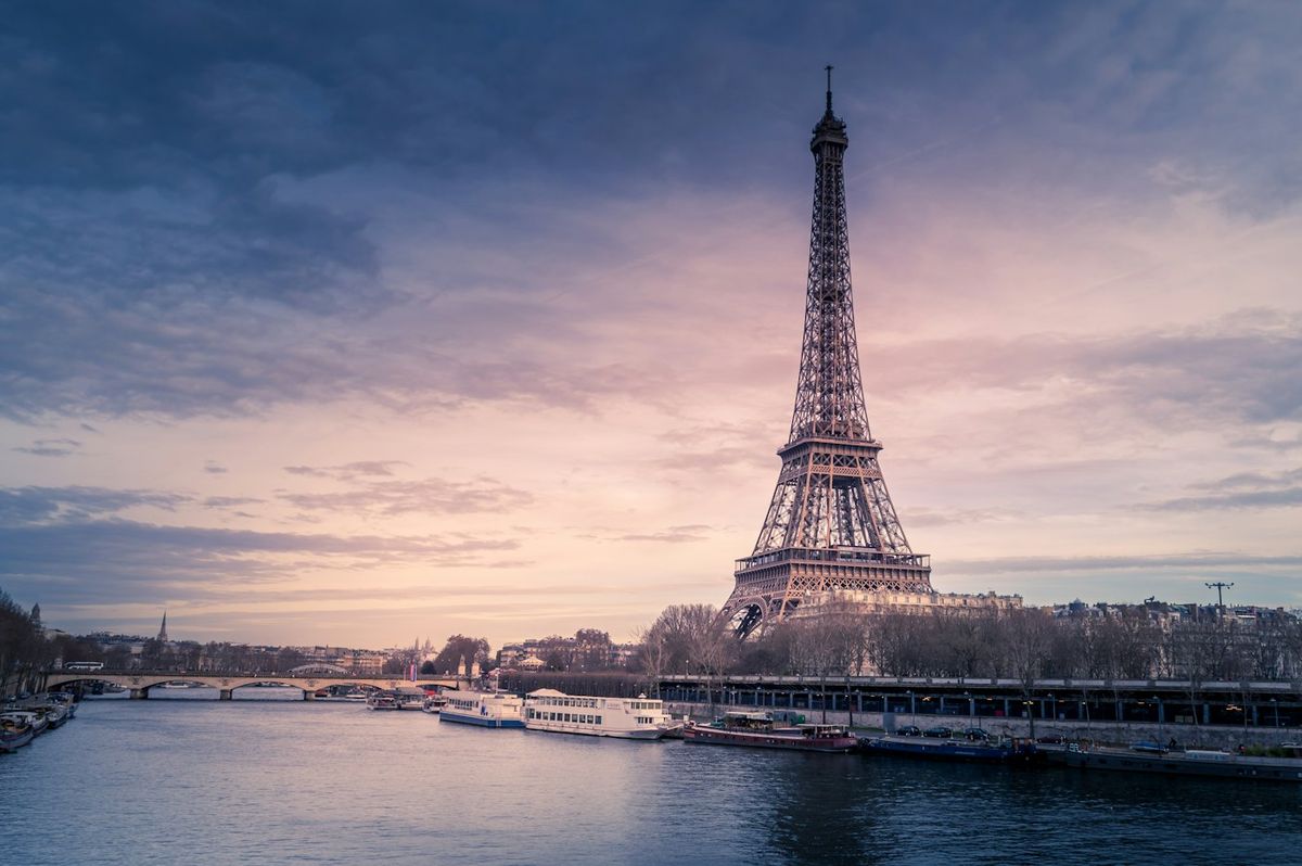 The Eiffel Tower beside the Seine at dusk